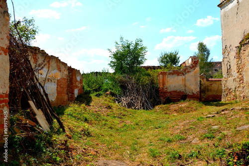 Ruins. Fortified medieval saxon evangelic church in the village Felmer, Felmern, Transylvania, Romania. The settlement was founded by the Saxon colonists in the middle of the 12th century photo