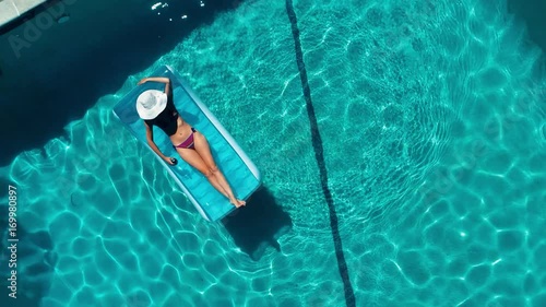 Young pretty woman lying on air mattress on the lake
