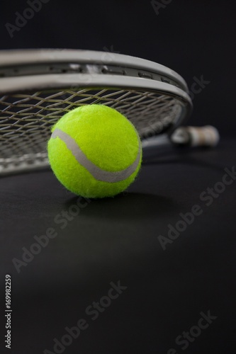 Close up of silver racket on tennis ball
