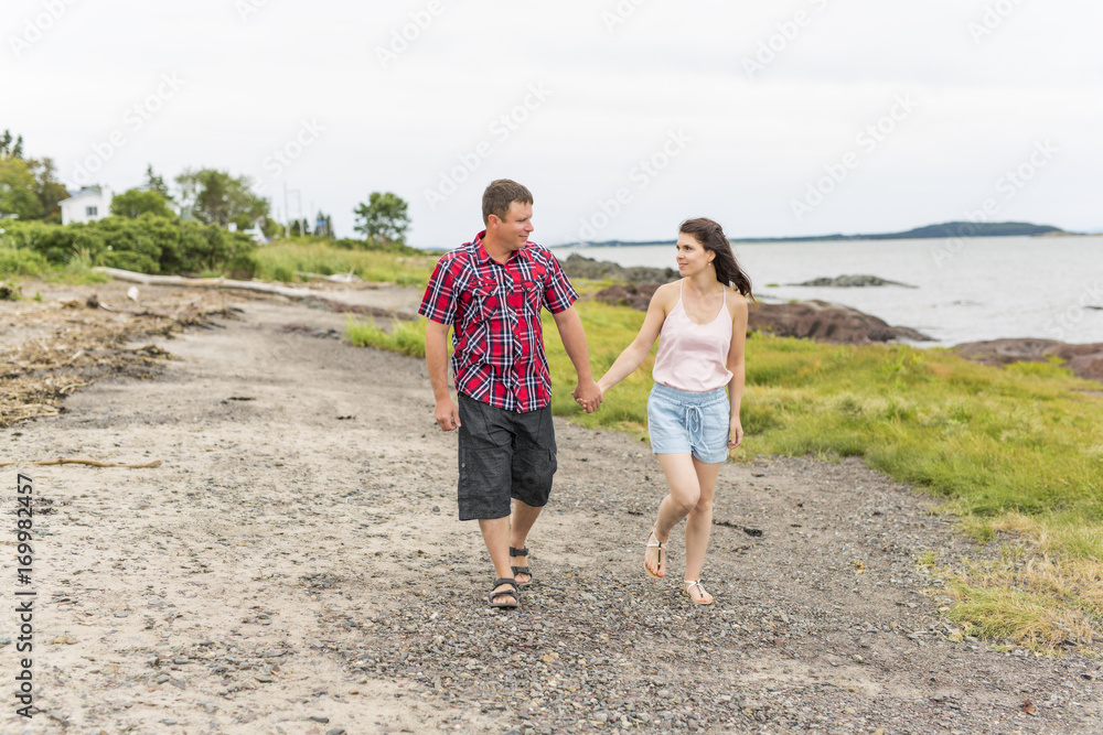 portrait of living young couple at the beach portrait of living young couple at the beach