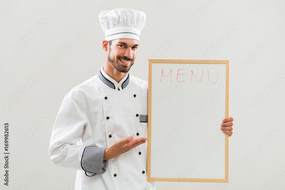 Chef is showing whiteboard on gray background. Chef is showing whiteboard on gray background.
