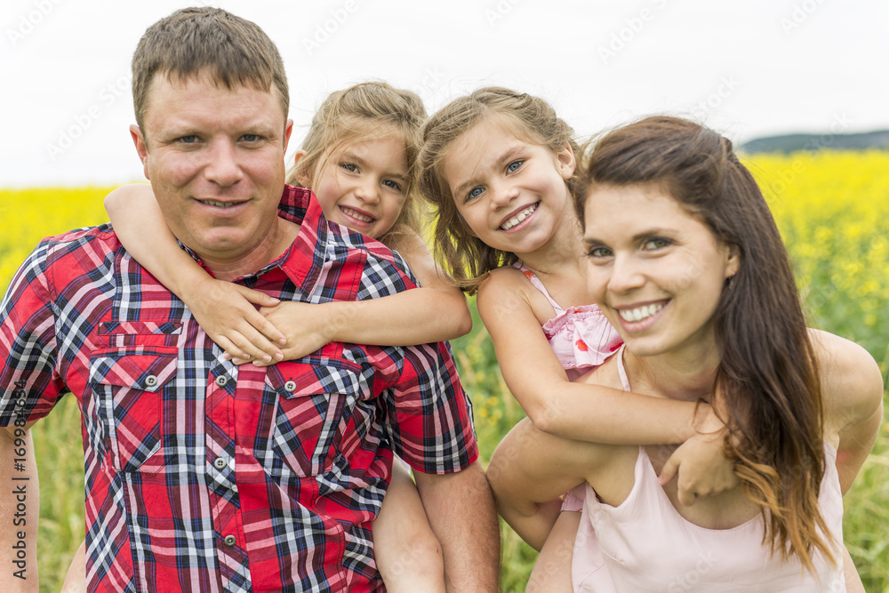 Family outdoors on a yellow field Family outdoors on a yellow field