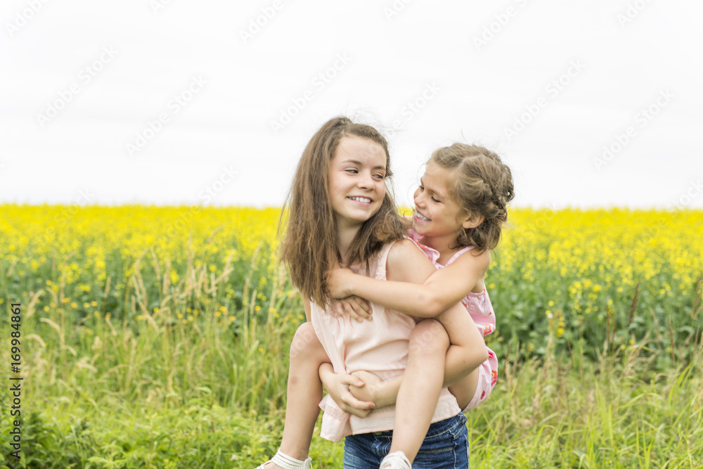 beautiful girls in a field of yellow flowers beautiful girls in a field of yellow flowers