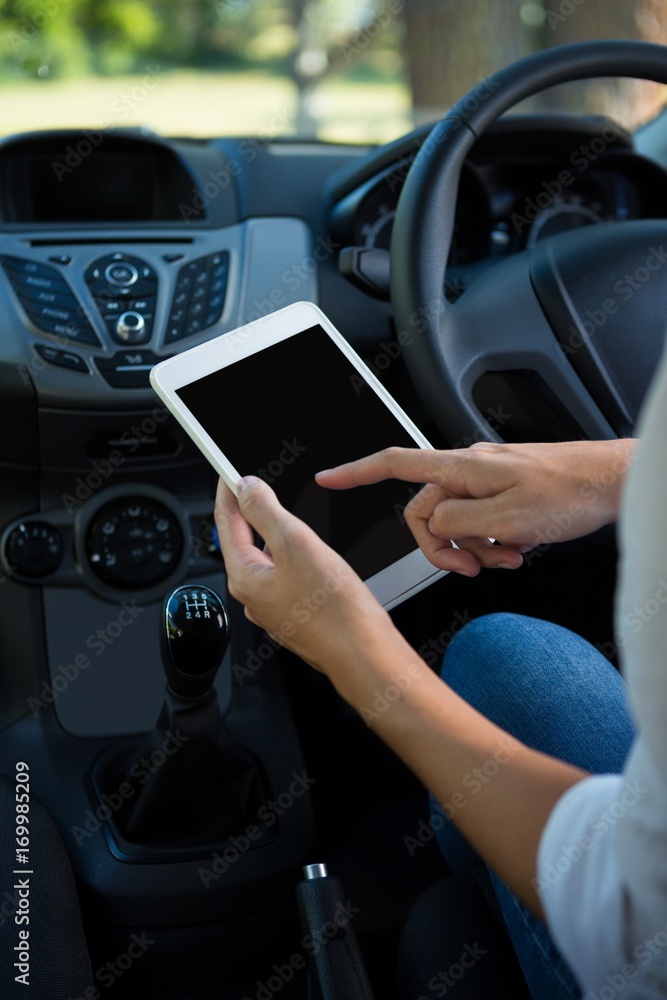 Woman using digital tablet in the car Woman using digital tablet in the car