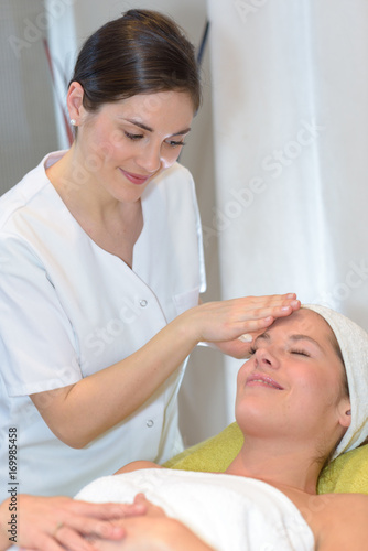 brunette getting head massage spa treatment