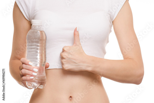 Female hands bottle of water belly