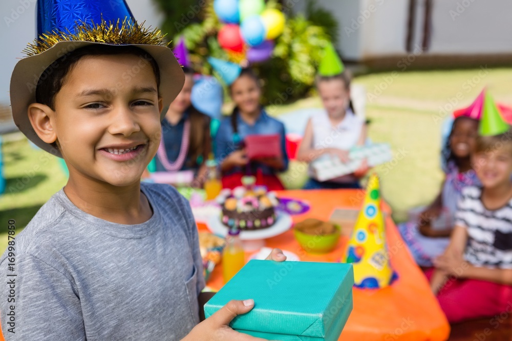 Portrait of boy showing gift box Portrait of boy showing gift box