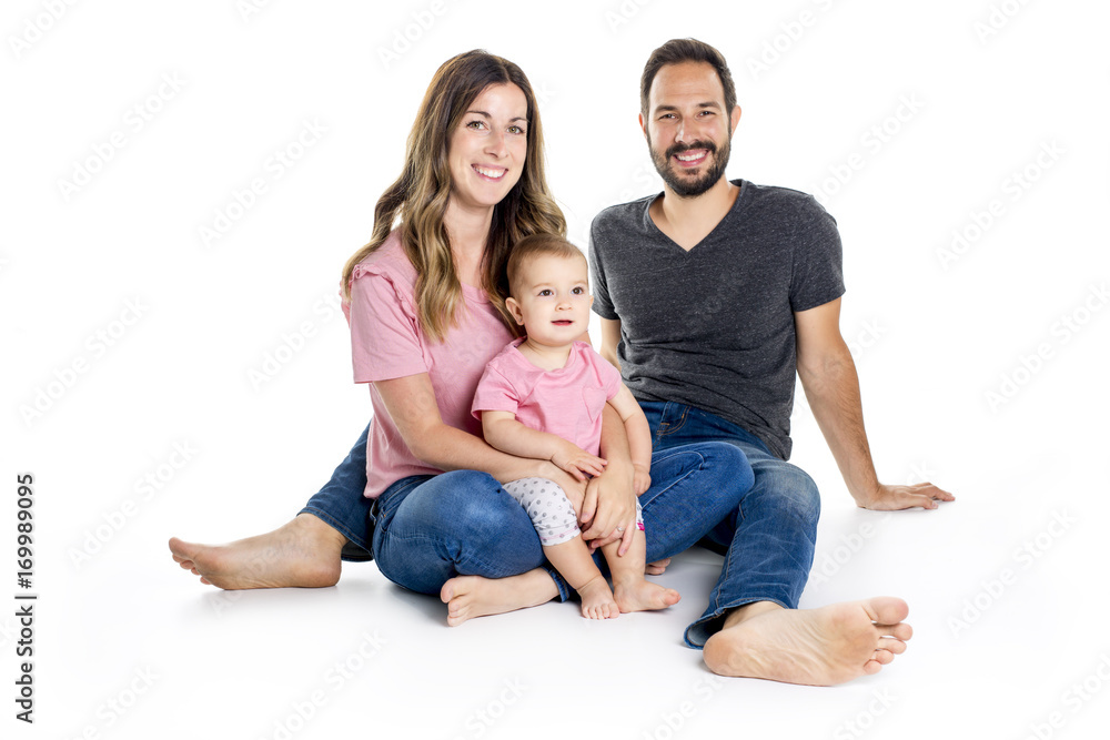 Photo of the happy young family with little child sitting on the floor Photo of the happy young family with little child sitting on the floor