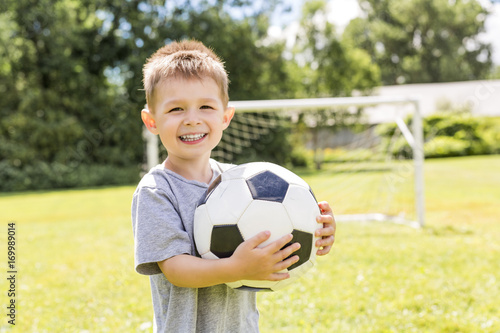Portrait of young boy with soccer ball © Louis-Photo