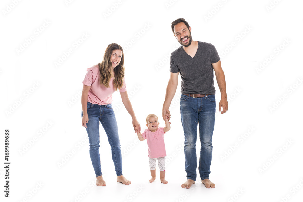 Couple of young parents helping their baby to make first steps on floor in their home Couple of young parents helping their baby to make first steps on floor in their home