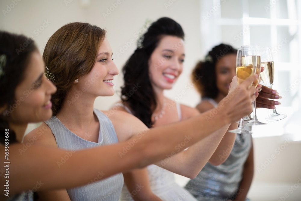 Bride and bridesmaids toasting champagne Bride and bridesmaids toasting champagne