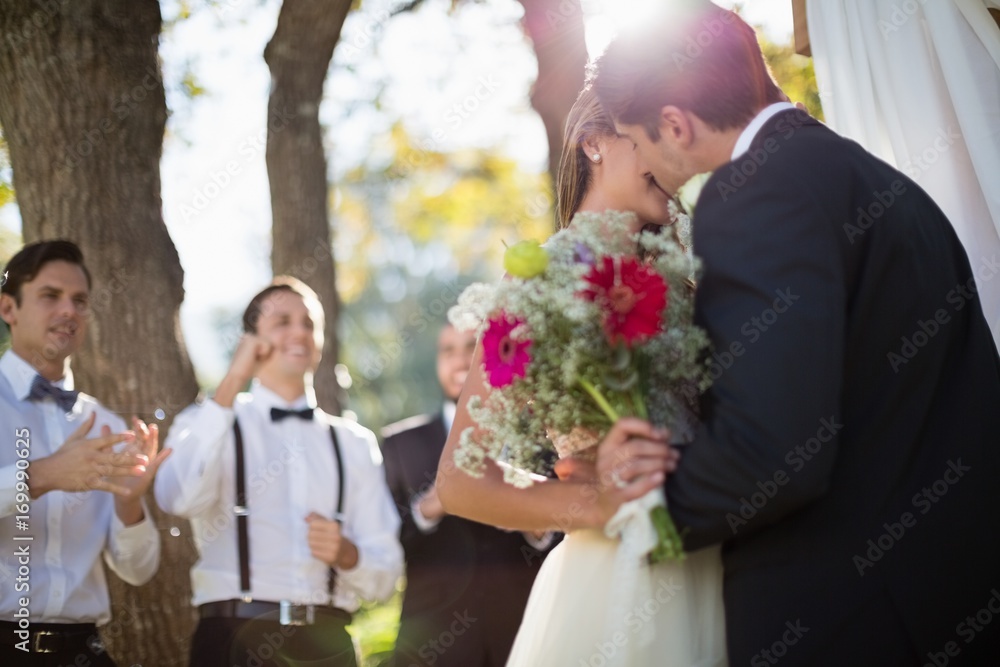 Affectionate couple kissing each other in park Affectionate couple kissing each other in park