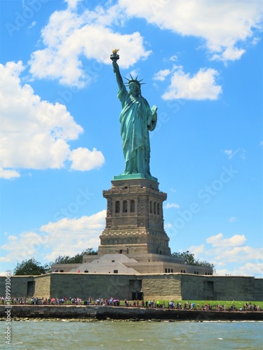 The Statue of Liberty in New York City with a blue sky background