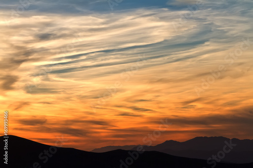 Red sunrise with clouds (sunset) in mountains