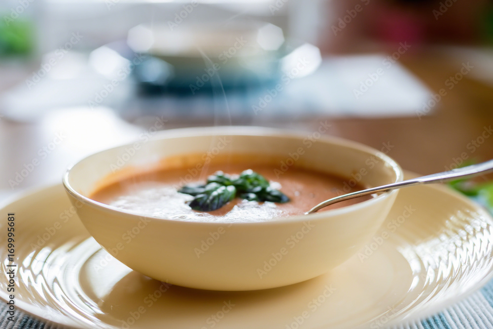 Closeup of warm tomato basil soup for lunch Closeup of warm tomato basil soup for lunch