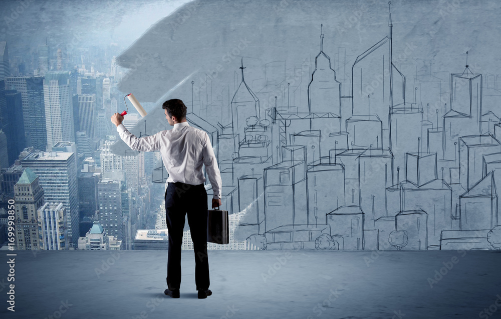 Elegant salesman repainting the city on wall Elegant salesman repainting the city on wall