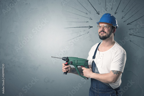 Worker standing with tool.