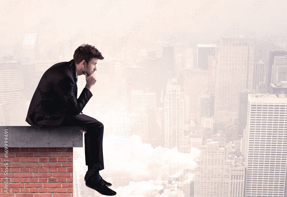 Office worker sitting on rooftop in city Office worker sitting on rooftop in city