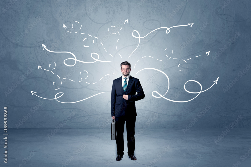 Businessman standing with winding arrows around Businessman standing with winding arrows around