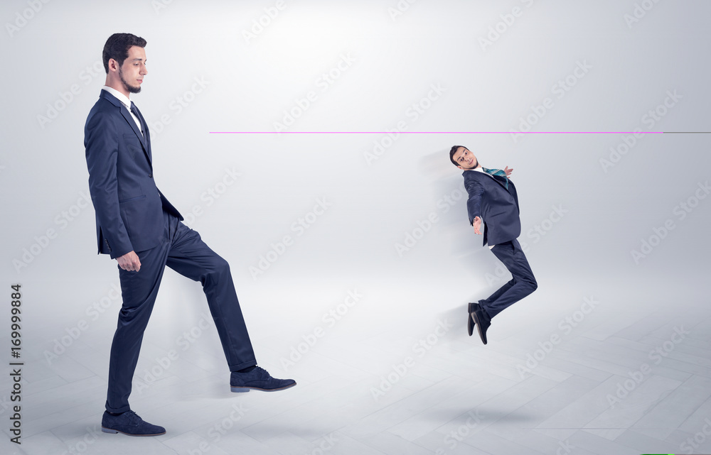 Fototapeta premium Small man fired by boss with white wallpaper
