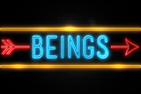 Beings  - fluorescent Neon Sign on brickwall Front view