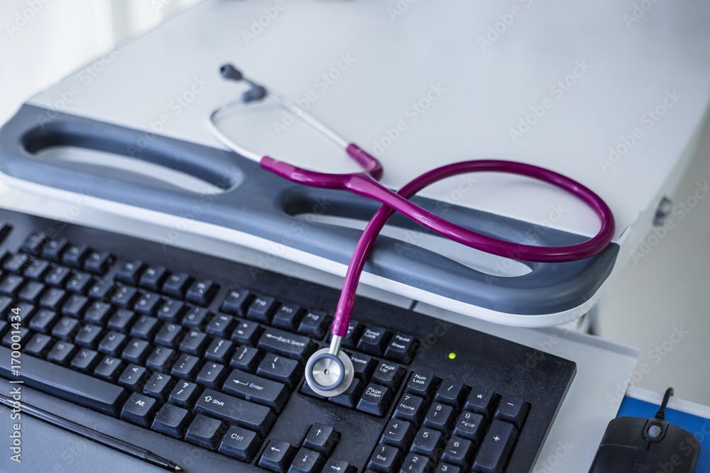 Stethoscope on a computer keyboard at a hospital Stethoscope on a computer keyboard at a hospital