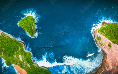 Aerial view of Tropical Sandy Beach. Sea Surface Aerial View. From Clear Blue Sky. Above Ocean. Aerial View of Forest. Palm and Paradise Beach. Big Waves, Green Background. Untouched Tropical Beach