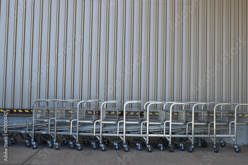 row of empty shopping carts in the big supermarket 