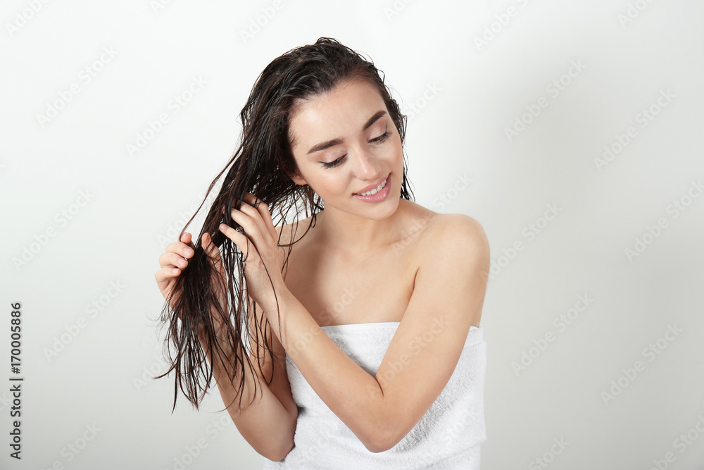 Young woman in towel after shower on white background Young woman in towel after shower on white background