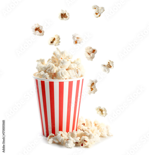 Cup and tasty popcorn on white background