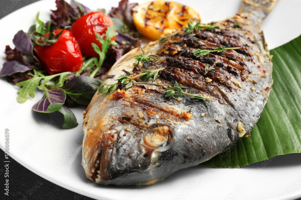 Plate with delicious fried fish, closeup