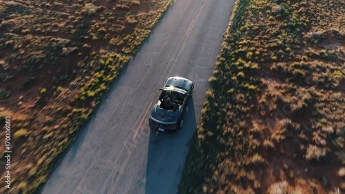 4k Aerial Flying Above White Convertible Car Driving Along America Highway