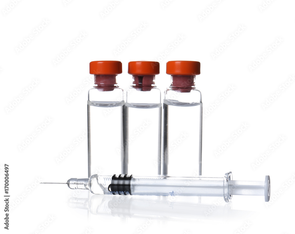 Ampules with vaccine and syringe on white background Ampules with vaccine and syringe on white background