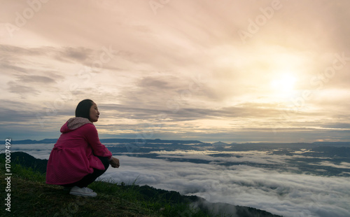 Women sitting morning sun in mist and fog scenery mountain background   © sompong_tom