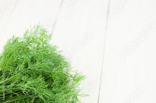 Heap of green fresh raw dill on old wooden white rustic planks