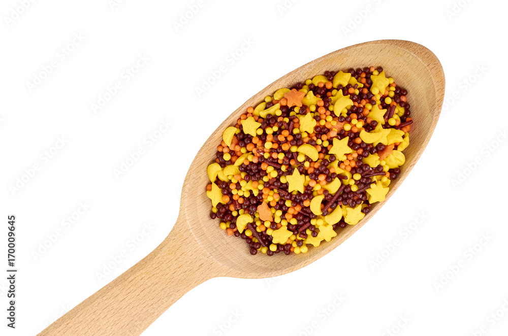 Wooden spoon with sprinkles for backing. Isolated on white background Wooden spoon with sprinkles for backing. Isolated on white background