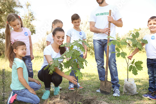 Young volunteers with child...