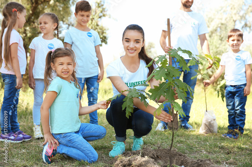 Young volunteers with child...