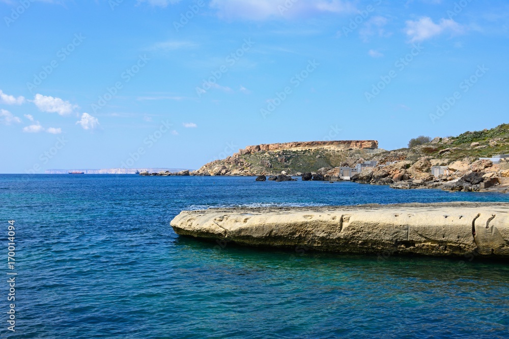 View of Ghaja Tehheiha Bay with the rocky coastline in the foreground, Ghajn Tuhheiha Bay, Malta.