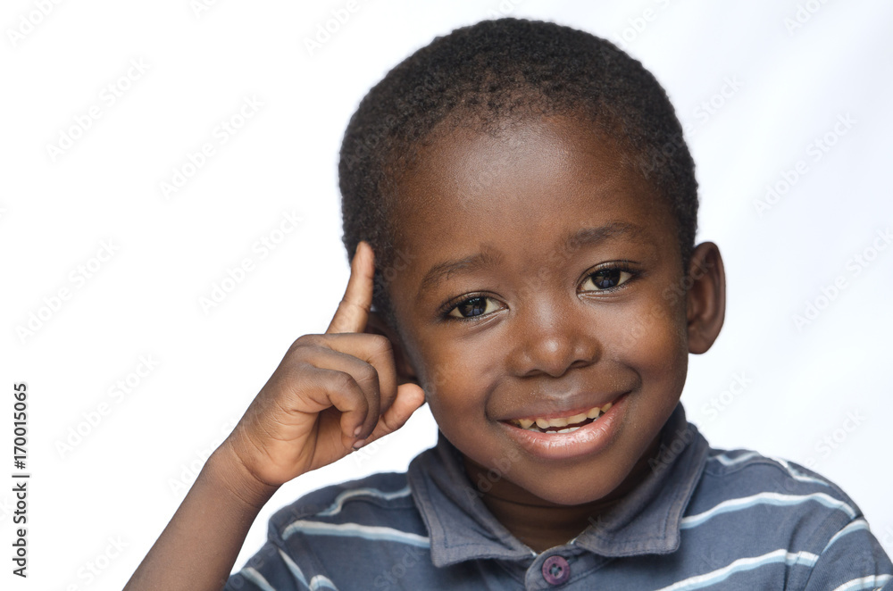 Little African boy thinking with finger pointed on his head isolated on white Little African boy thinking with finger pointed on his head isolated on white