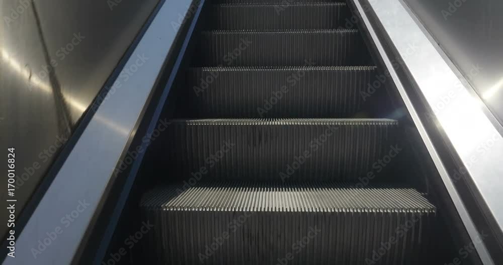 Escalator steps rising upward
Escalator steps rising upward
