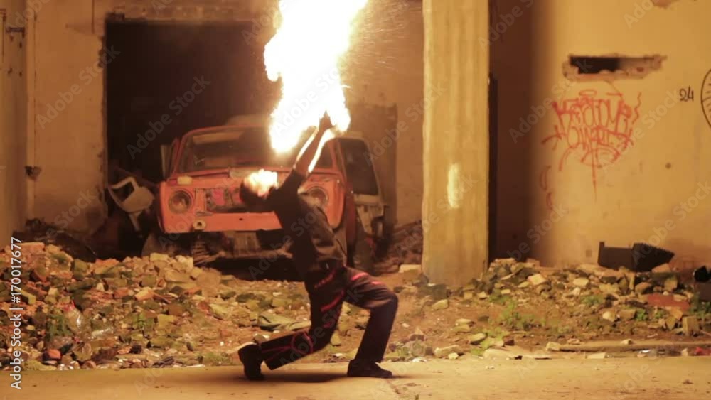 Male fire show performer at night. Poi performance. Male fire show performer at night. Poi performance.