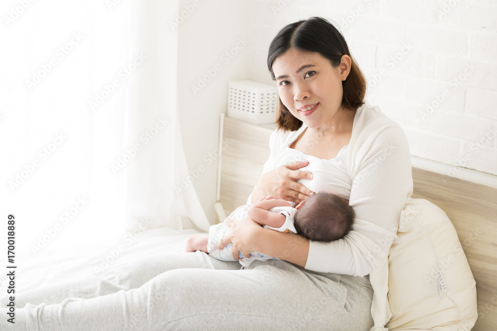 Asian mother holding her newborn baby boy and breastfeeding, Milk mother for child concept Asian mother holding her newborn baby boy and breastfeeding, Milk mother for child concept