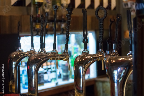 Cranes keg with work instrument tap handles in bar photo