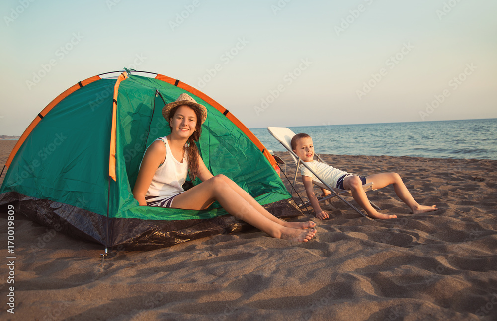 Beach Camping. Kids camping and activity on the beach at sunset