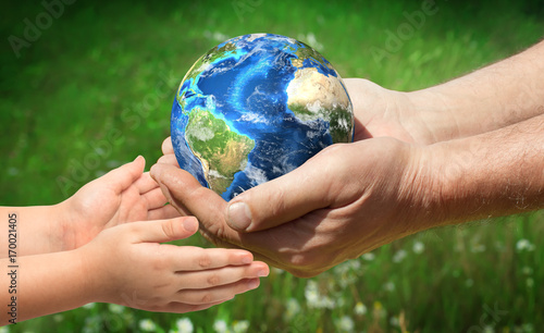 The man gives planet Earth to baby. Ecology concept. Elements of this image furnished by NASA