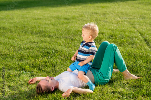 Happy woman and child having fun outdoor on meadow