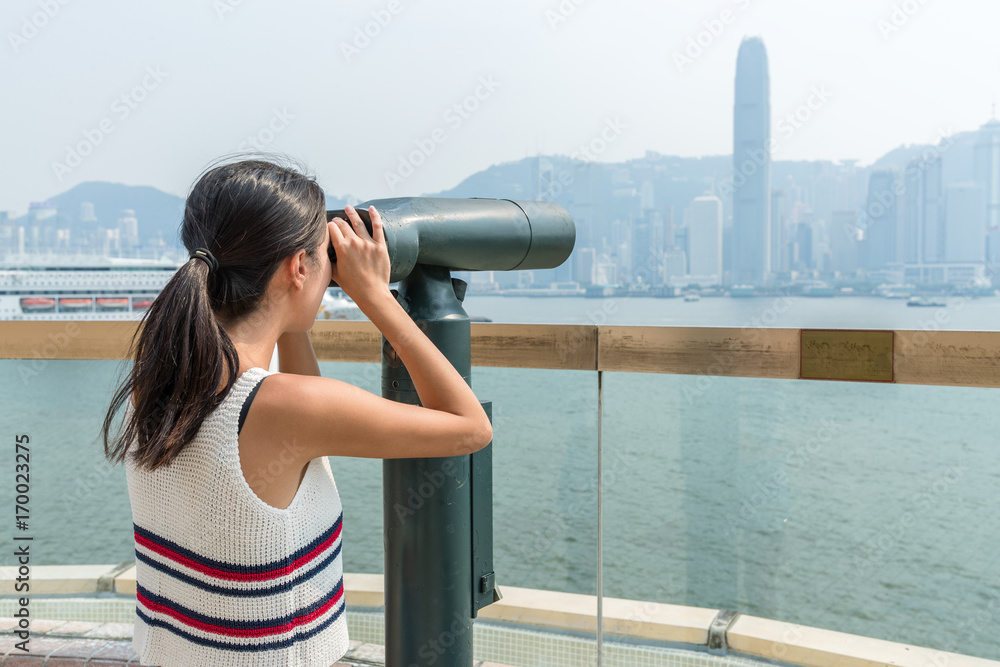 Woman travel in Hong Kong and using binoculars
