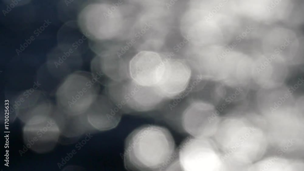 Slow motion of bright sparkling water in darkness. Slow motion, abstract blurry background at the water level. Slow motion of bright sparkling water in darkness. Slow motion, abstract blurry background at the water level.