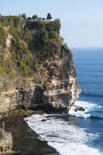 Alone temple on a strong cliff  at Uluwatu, Bali, Indonesia photo